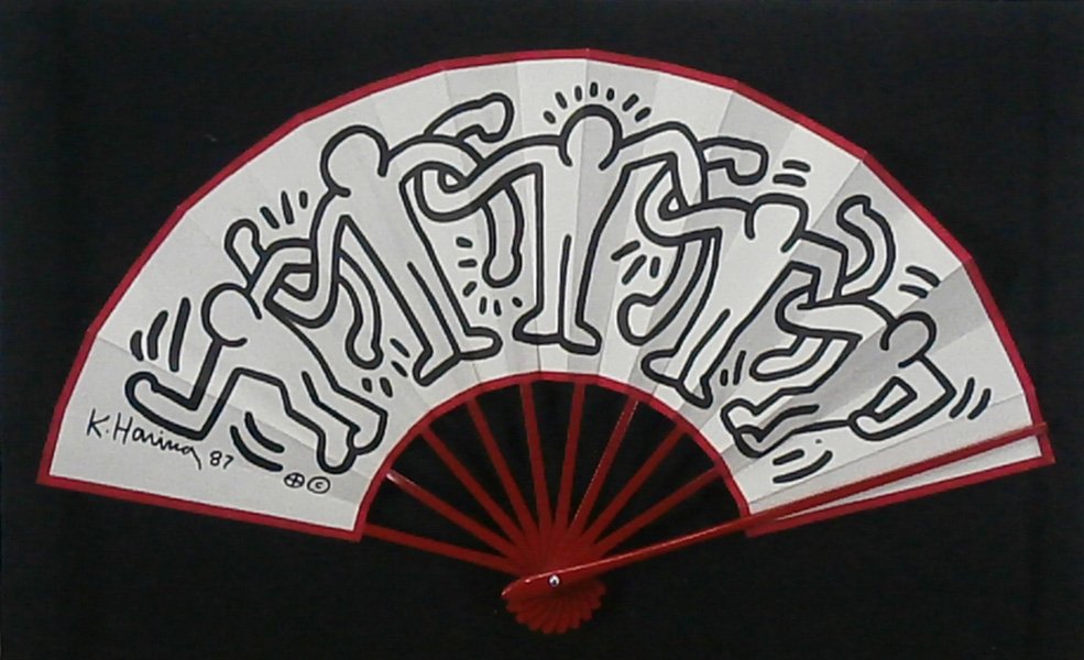 Keith Haring (1958-1990) American: UNTITLED, 1987, artist’s design fan from his Tokyo Pop Shop, signed and dated in design lower left, 11 ½ x 20 ¼”, mounted in Plexiglas box.