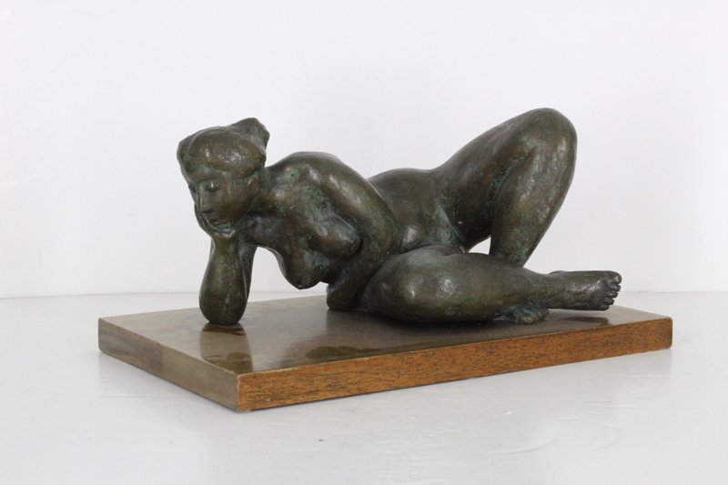 Artist unidentified (Later 20th Century) J. K. B.: RECLINING NUDE WOMAN, 1976, cast bronze with green patina, signed JKB and numbered III/VII, mounted to wood base, overall 8 x 16 x 10”, in good studio condition.