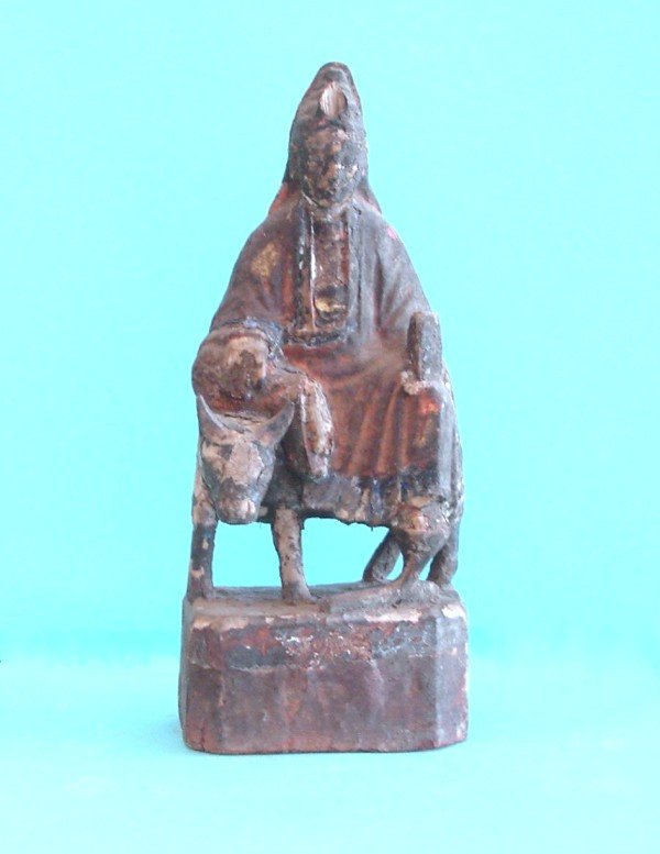 Chinese Wooden Altar Figures: WOMAN RIDING A DONKEY, a hand-carved and painted wooden alter figures, 11" tall, paint worn and chipped, natural cracking from considerable age.