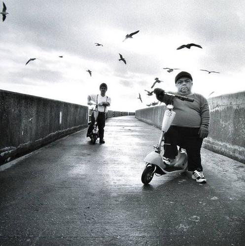Michal Chelbin (b.1974) the scooters, england, 200: Michal Chelbin (b.1974) the scooters, england, 2003Gelatin silver print, printed 2003, signed and editioned on verso, edition 9/25, framed, 50x60cm (20x24in.). This print is from a compelling