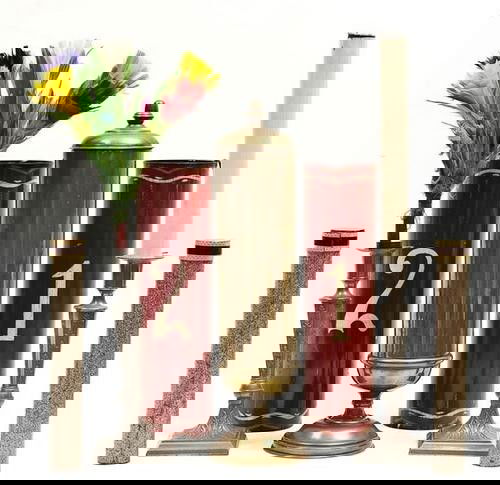 Early props: Early props,comprising a large copper coffee vase, 365mm. high; a pair of decorative metal candlesticks for candle to flowers illlusion, 442mm. high; and a set of organ tubes, painted a deep