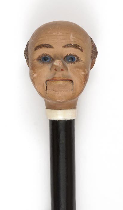 Ventriloquist's Cane: Ventriloquist's Cane,the black cane with the model of a ventriloquist doll's head, 885mm. overall, the head 88mm. high