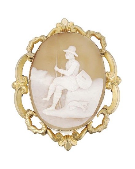 A late 19th century gold and shell cameo, the came: A late 19th century gold and shell cameo, the cameo depicting a seated fisherman, within a openwork scroll border, 6.8cm long