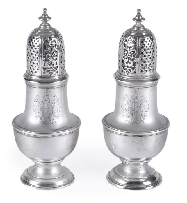 A pair of George II silver vase shape casters by T: A pair of George II silver vase shape casters by Thomas Bamford I, London 1732, with turned finial to the domed cover pierced alternately with panels of trellis and scrolls, moulded rims and