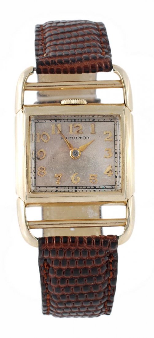 Hamilton, Medwick, a gold filled driver's wristwat: Hamilton, Medwick, a gold filled driver's wristwatch, circa 1938, the two piece case with hinged ladder lugs, and a winding crown at 12 o'clock, the silvered dial with applied gilt Arabic num