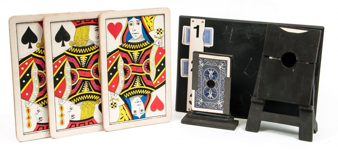 Card Magic. A small collection,: including The Absconding Queen, with instructions, the metal frame with pierced jumbo cards on wooden base; a similar trick with cards in a black wooden frame and easel; a Demon wooden tray with two s