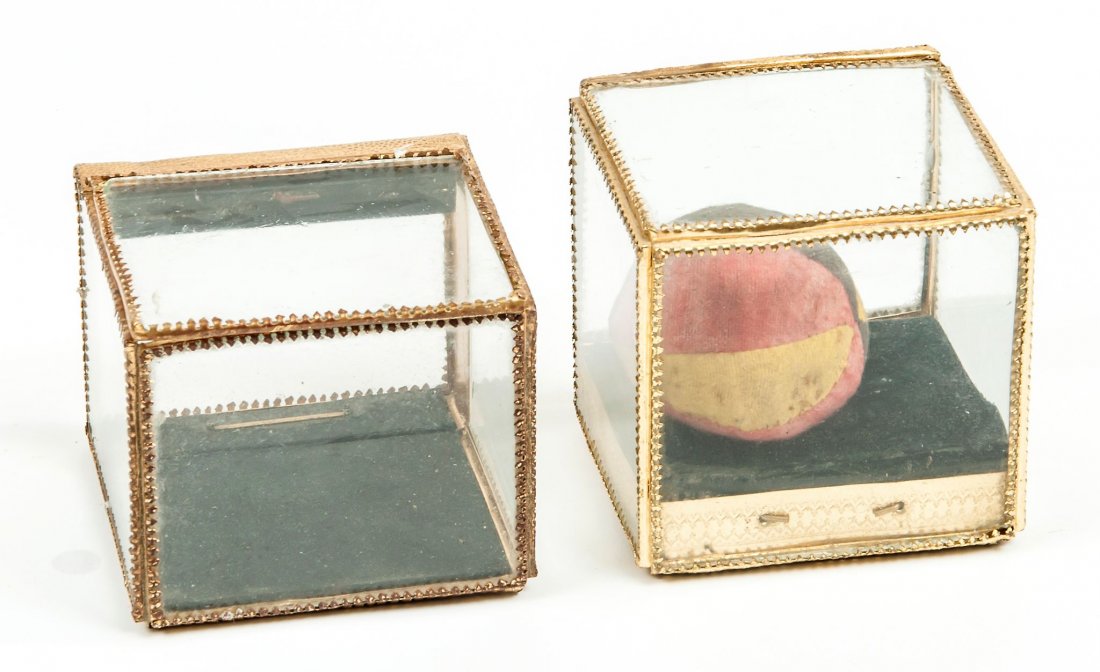 Crystal Caskets,: two examples with similar gilt decoration, each with hinged side and fold-down inner panel, one containing a spring production ball, 100mm. high , [c.1900].