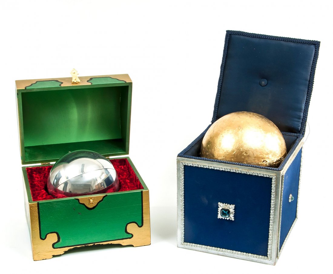 Floating Sphere,: with instructions, the silver globe in padded decorated wooden case, 160mm. diameter, the case 225mm. high, Owen Magic Supreme , [c.1961]; another example, the golden sphere in wooden box painted blue