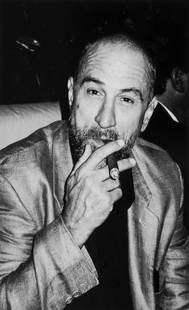 Roxanne Lowit (dates unknown) - Robert De Niro Smoking,: Gelatin silver print, printed later, signed, titled, dated and editioned 1/25 in pencil verso, 55.5 x 36.9cm (21 7/8 x 14 1/2in)