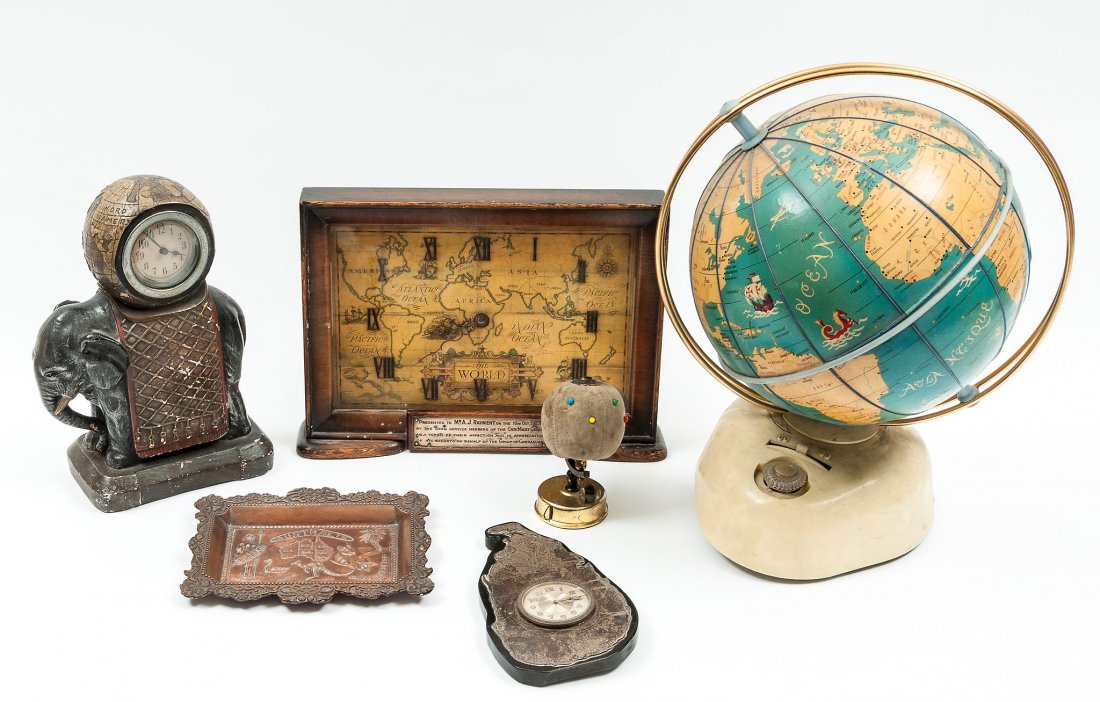 A radio modelled as a terrestrial globe, surmounted: A radio modelled as a terrestrial globe, surmounted upon a wireless base, 33 cm. high; A timpiece silver model of Ceylon, hallmarked Birmingham, 1928, 17 cm. high; with two other various timepieces, a