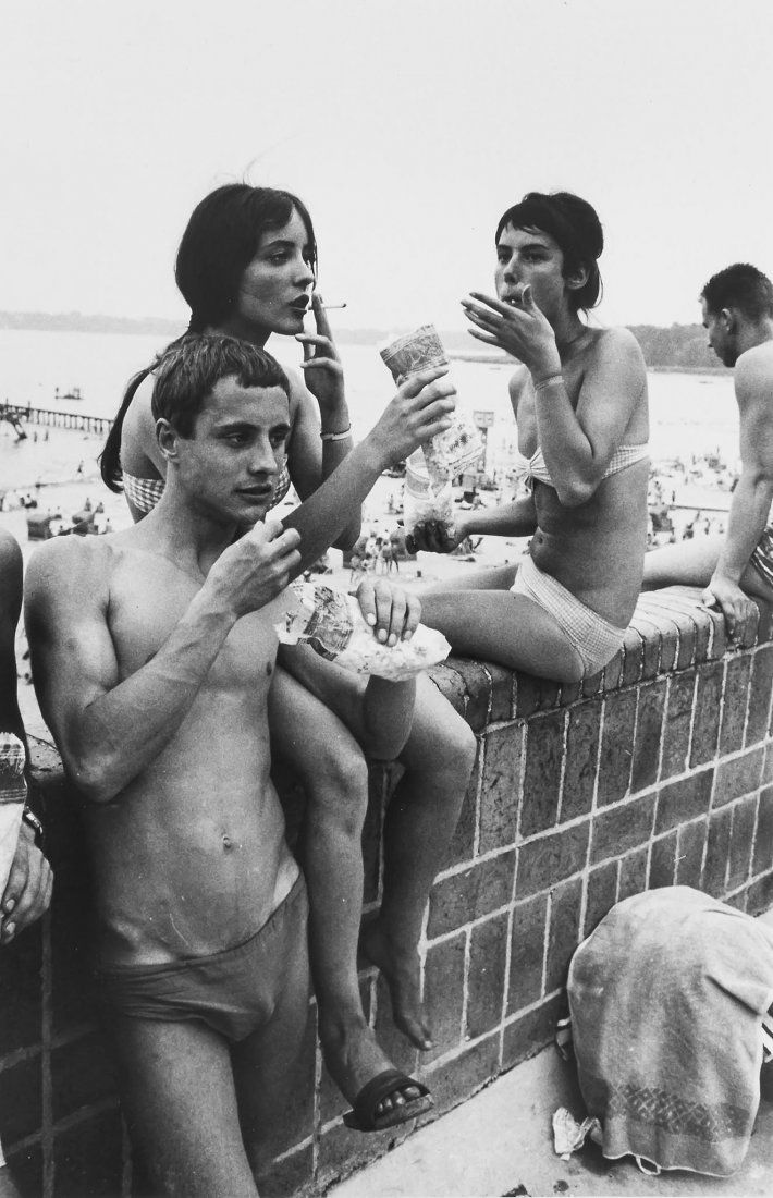 Will McBride (b.1931) - Eating Popcorn at Strandbad: Gelatin silver print, printed later, signed, titled and dated in pencil verso, 25.6 x 16.6cm (10 x 6 1/2in) IMPORTANT: This lot is sold subject to Artists Resale Rights, details of which can be found