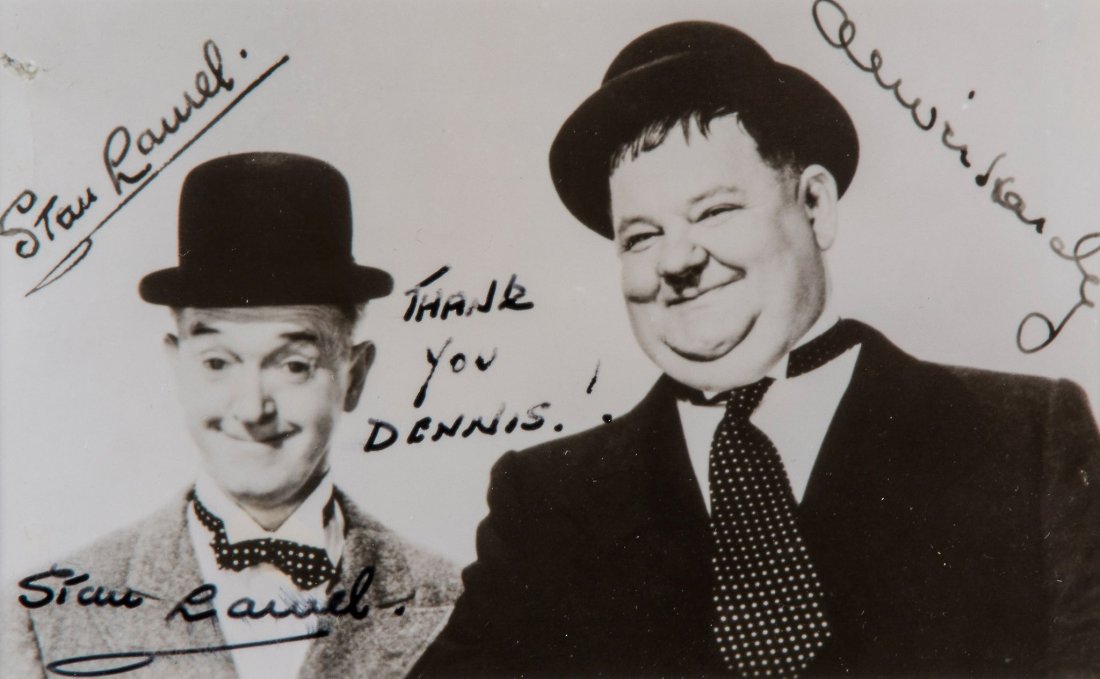 LAUREL, STAN - Vintage black and white, head and: Vintage black and white, head and shoulders photograph of Stan Laurel and Oliver Hardy wearing their bowler hats, featuring facsimile autographs of both the comic actors, signed by Stan Laurel and ins
