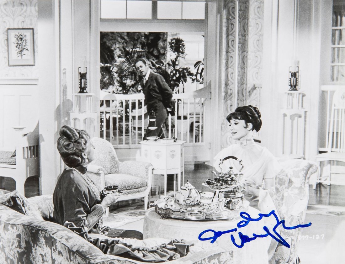 HEPBURN, AUDREY - Black and white photograph of Audrey: Black and white photograph of Audrey Hepburn together with Rex Harrison and Gladys Cooper in a scene from the 1964 movie 'My Fair Lady', signed "Audrey Hepburn" in blue ink, tiny blots to signature, m