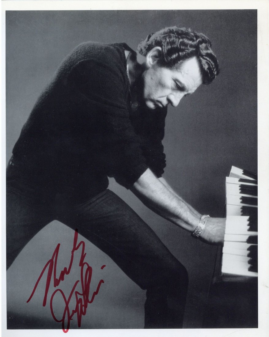 LEWIS, JERRY LEE - Black and white photograph of Jerry: Black and white photograph of Jerry Lee Lewis at the piano, signed in red marker on lower margin, minor creasing, 10x 8".
