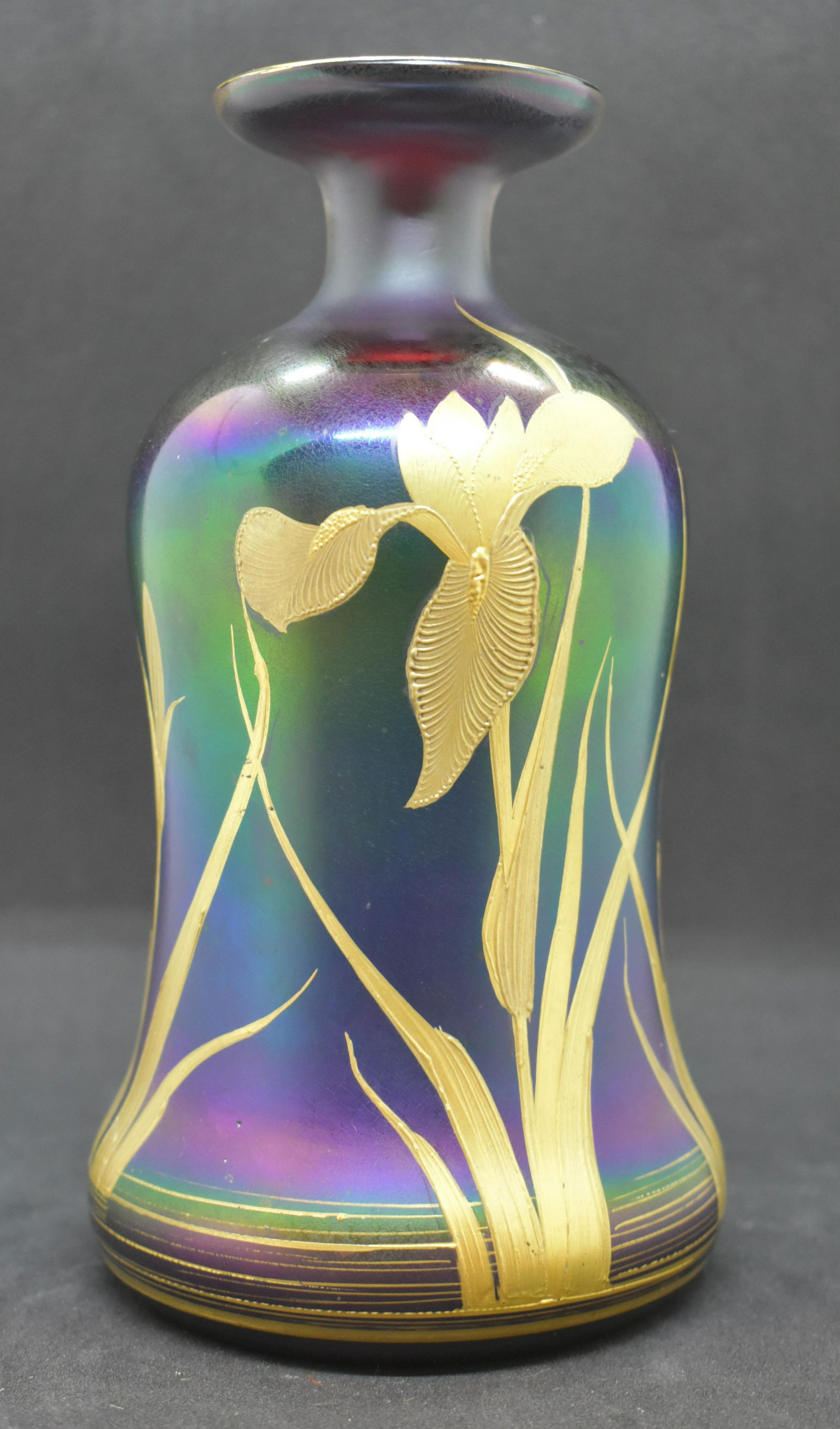 Antique Bohemian Art Glass Iridescent Iris Vase: Absolutely gorgeous ruby red glass decanter vase with iridescent purple/blue glaze and gilt painted Iris flowers! We have researched to the best of our ability to correctly attribute a maker to this p