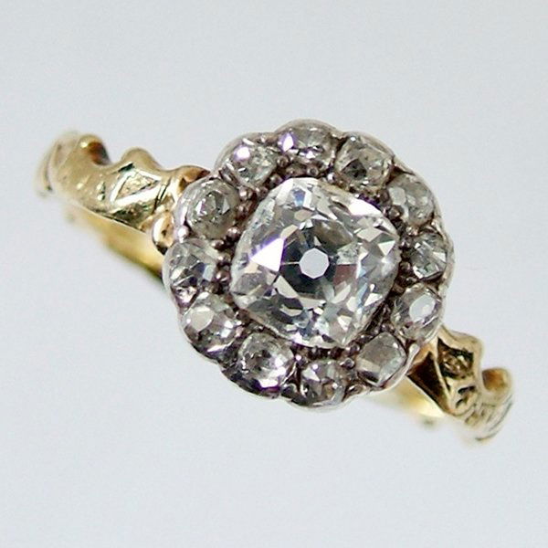 Late Victorian diamond cluster mourning ring, the: Late Victorian diamond cluster mourning ring, the central cushion form stone approximately 5.35mm.