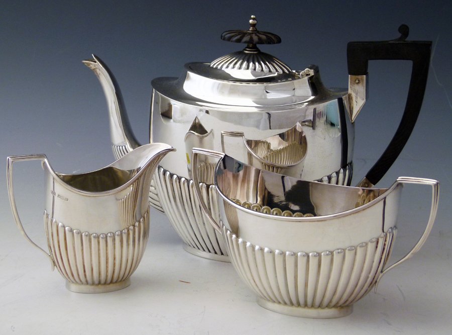 Georgian style half reeded silver tea pot, Walker &: Georgian style half reeded silver tea pot, Walker & Hall Sheffield 1900, and a similar sugar basin and milk jug, R&B, Sheffield 1904, 28oz 18dwt all in (3).