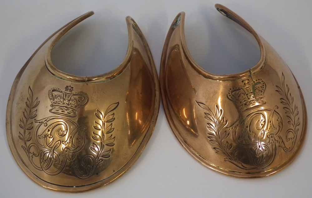 Pair of Georgian plated copper gorgets, engraved with a: Pair of Georgian plated copper gorgets, engraved with a crowned GR cipher between laurel branches, (2) 11cm long
