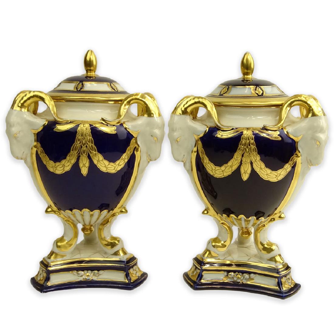 Pair Royal Dux Porcelain Cobalt and Parcel Gilt Covered: Pair Royal Dux Porcelain Cobalt and Parcel Gilt Covered Urns. Ram's head handles. Signed. Light wear and One with restoration to rim. Measures 10" H. Shipping $ 65.00 (estimate $300-$400)