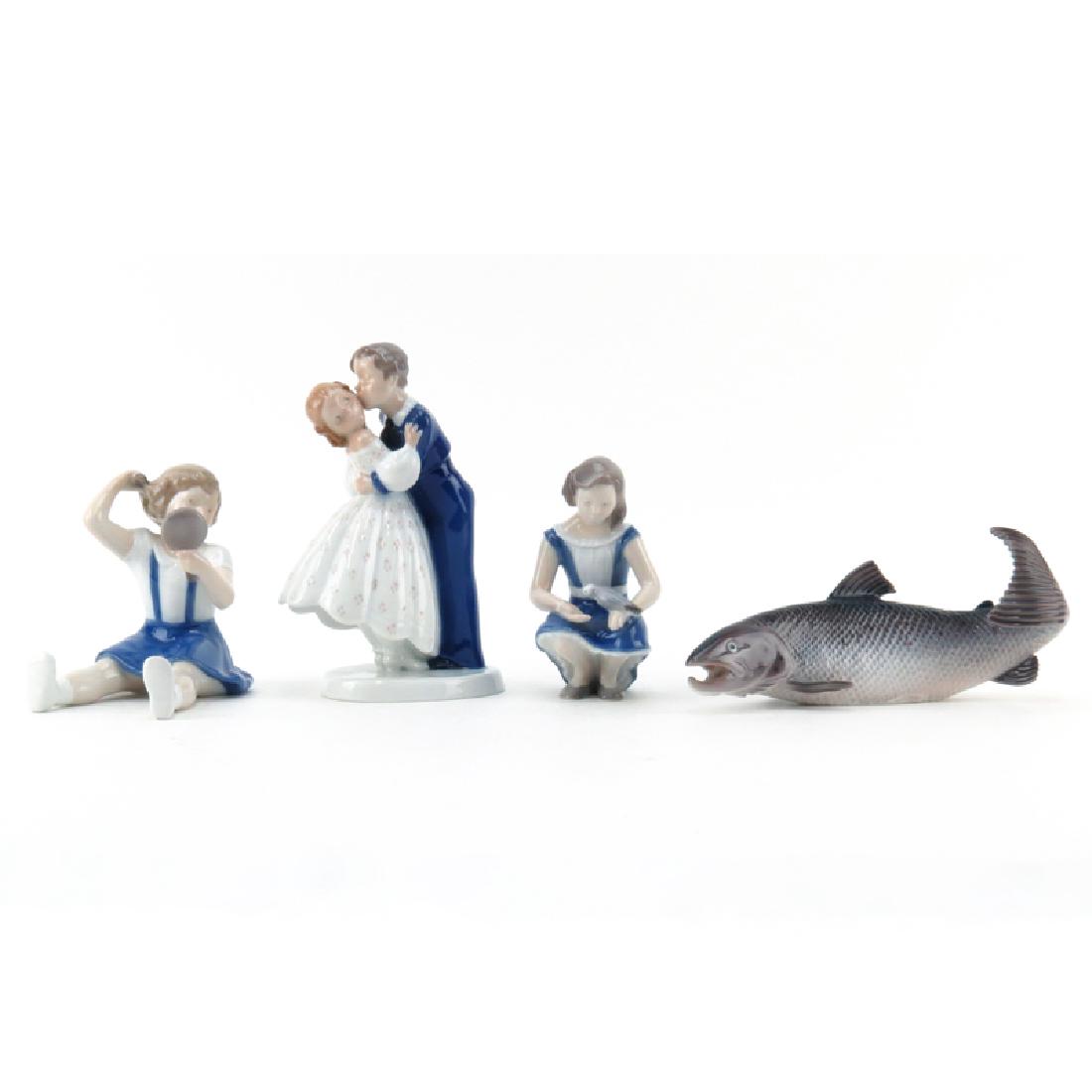 Grouping of Four (4) Bing and Grondahl Glazed Porcelain: Grouping of Four (4) Bing and Grondahl Glazed Porcelain Figurines. Includes: boy and girl #2162, girl with bird #2340, girl with mirror #2318, and salmon #2366. All in good condition. Largest measures