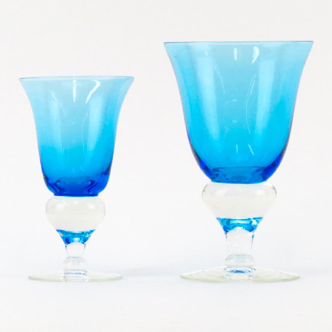 Grouping of Eleven (11) Mid Century Blue to Clear: Grouping of Eleven (11) Mid Century Blue to Clear Crystal Stemware. Unsigned. Nicks to rim on a few glasses. Taller glass measures 6" H, smaller measures 5" H. Provenance: Property of Irving Cowan and
