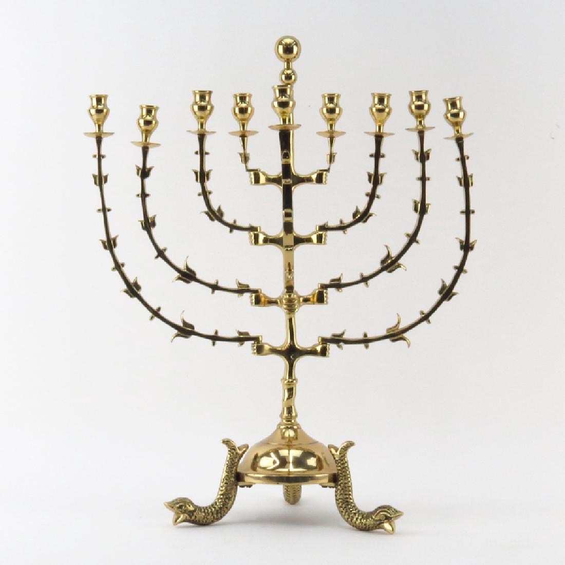 Art Nouveau style Judaica Brass Menorah. Stamped: Art Nouveau style Judaica Brass Menorah. Stamped Portugal on obverse. Removable arms standing on sea serpent feet. Good condition. Measures 20-1/4" H. Shipping $165.00 (estimate $150-$250)
