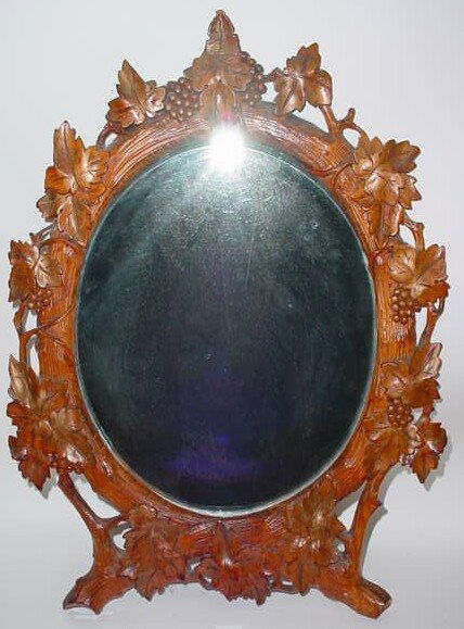 German Black Forest Carved Wood Table Top Mirror N: German Black Forest Carved Wood Table Top Mirror Now Converted to a Wall Hanging Mirror with Beveled Glass. Circa 1st Half 20th Century. Unsigned. Very Good Condition. Back of Mirror Now Fitted with C