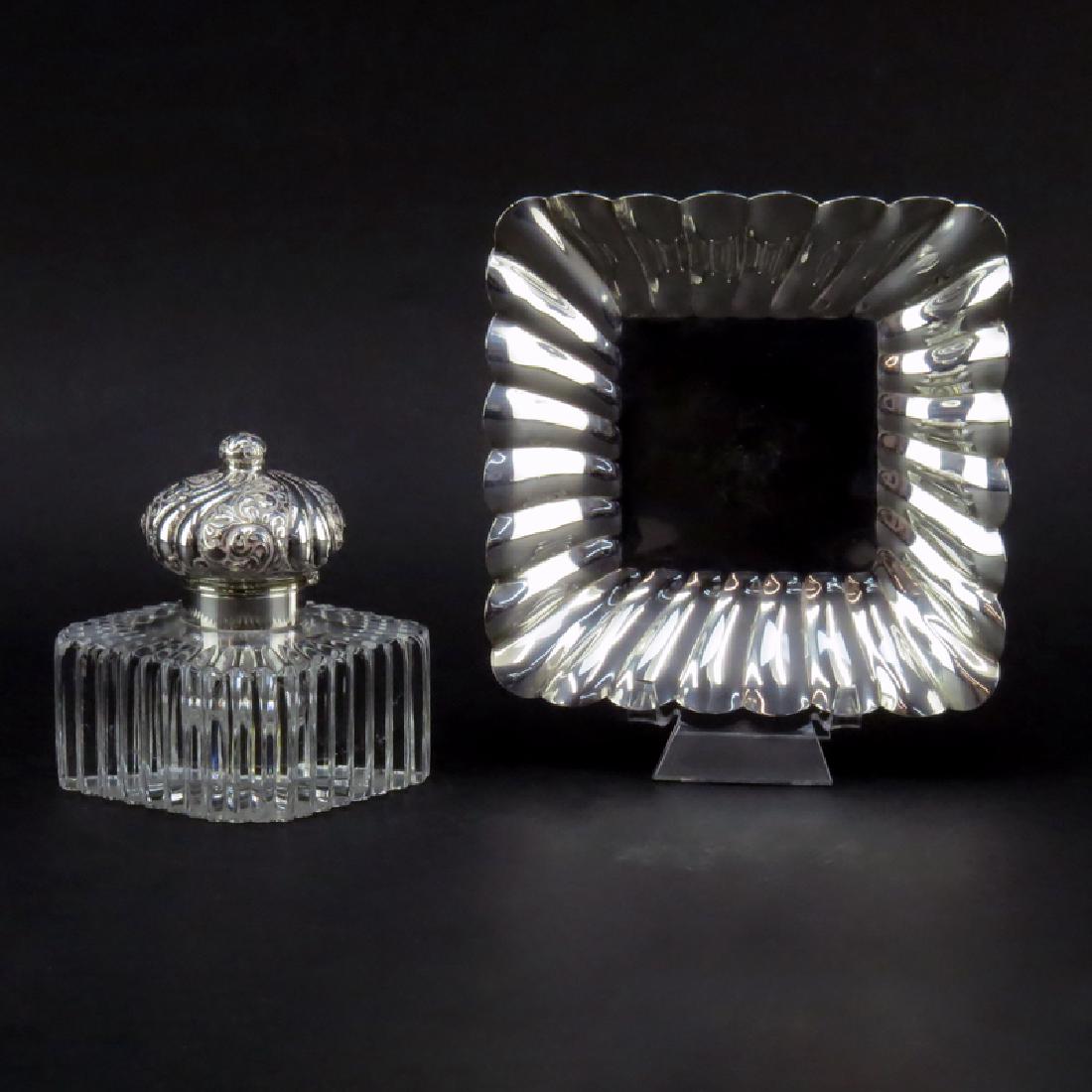 20th Century Sterling and Glass Inkwell and Tray. This: 20th Century Sterling and Glass Inkwell and Tray. This set boasts a sterling tray with a glass bottle and sterling hinged lid. Signed STERLING. Small chips and bottom scratches on bottle or in overall