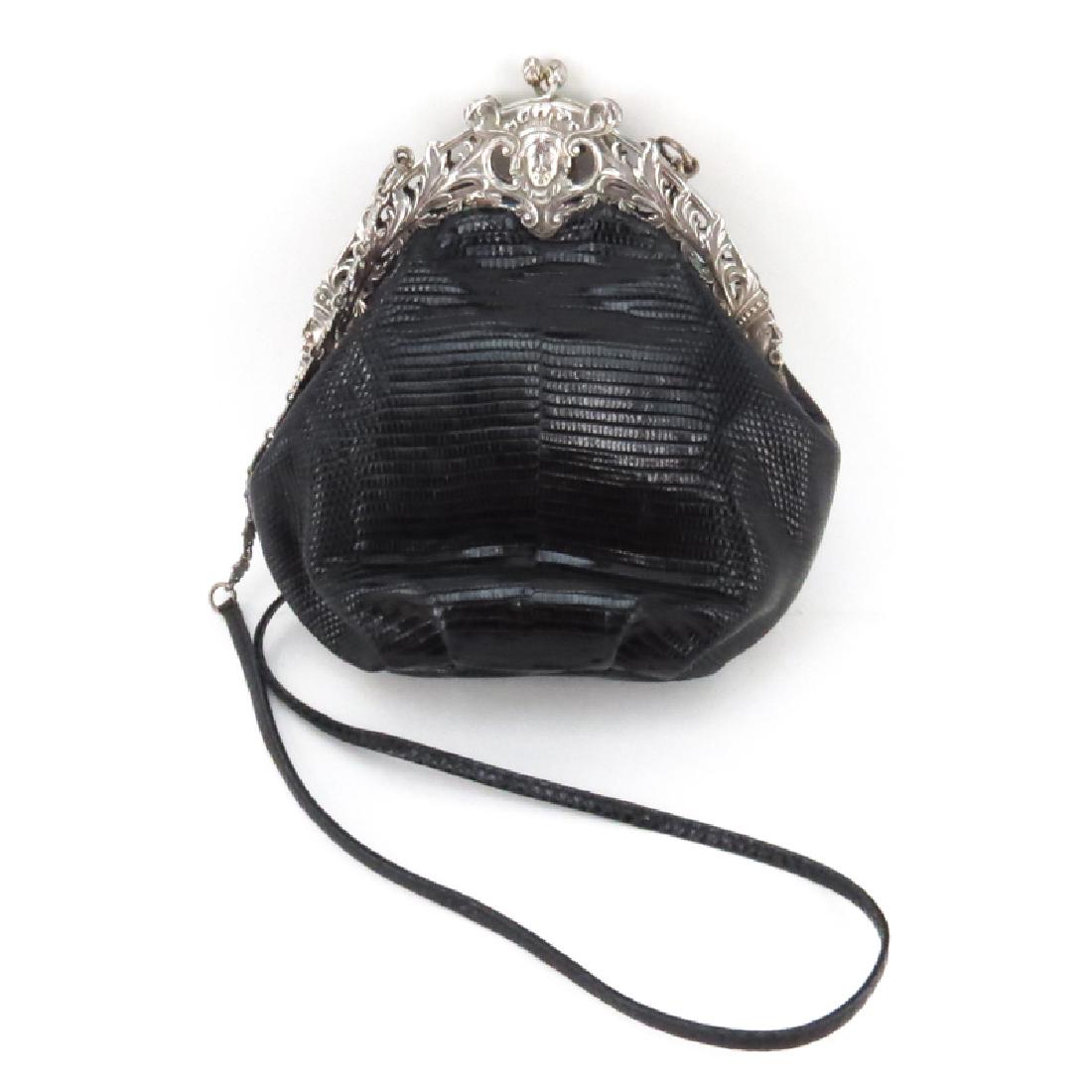 Silver framed Handbag. Modern lizard leather bag.: Silver framed Handbag. Modern lizard leather bag. Antique frame with Rococo figural motif. Unsigned. Good condition. Measures 8" H x 8" W, drop 19". Shipping $52.00 (estimate $150-$250)