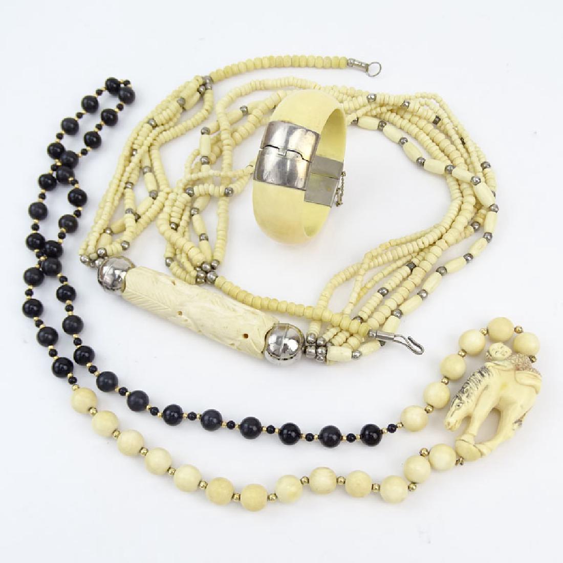 Three Piece Lot Including Carved and Black Onyx Bead: Three Piece Lot Including Carved and Black Onyx Bead Necklace, Carved Bone Necklace and Bangle Bracelet. Unsigned. Good vintage condition. Carved bone necklace measures 34-1/2" L. We Will Not Ship Thi