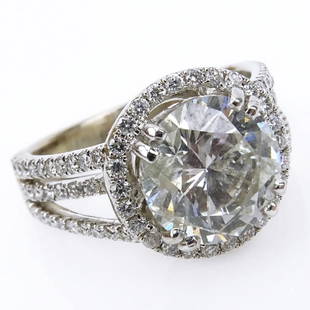 Approx.. 5.46 Carat TW Diamond and 18 Karat White Gold: Approx.. 5.46 Carat TW Diamond and 18 Karat White Gold Engagement Ring set in the Center with an Approx. 4.36 Carat Round Brilliant Cut Diamond I Color, I1 Clarity. Stamped 18K 750. Very good conditio