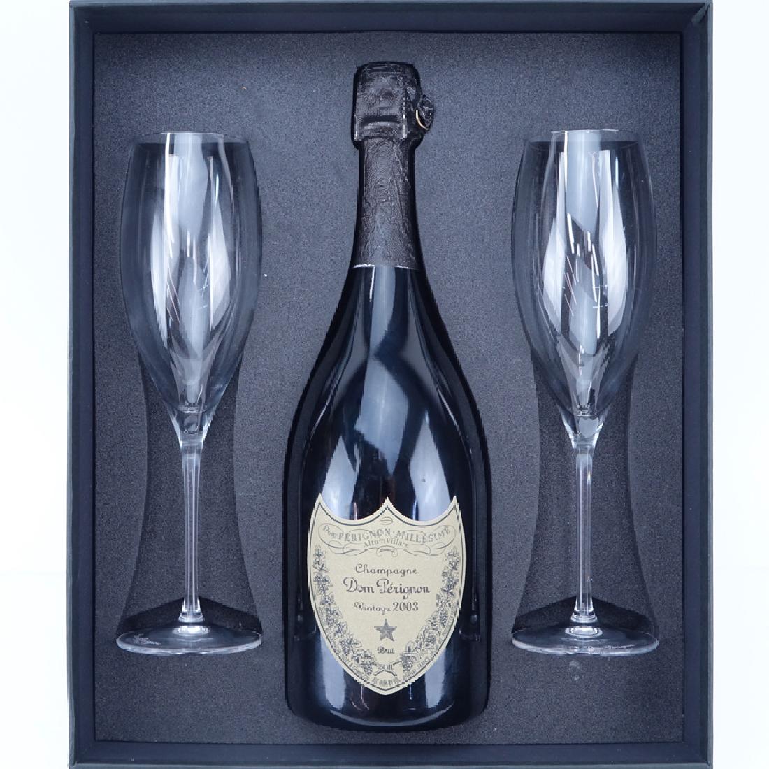 Vintage 2003 Dom Pérignon Champagne Bottle in: Vintage 2003 Dom Pérignon Champagne Bottle in Presentation Box. Includes two crystal champagne glasses with booklet. In unopened condition, box is not original to the bottle. Size 750 ML. The gallery