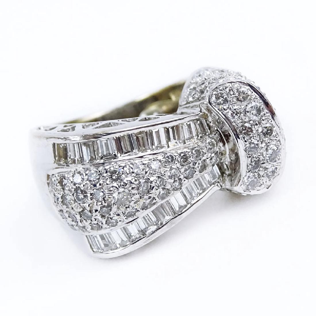 Round Brilliant Cut and Baguette Diamond and 18 Karat: Round Brilliant Cut and Baguette Diamond and 18 Karat White Gold Ring. Stamped 18K. Very good condition. Ring size 1-1/2 (with sizing balls). Approx. weight: 11.5 grams. Shipping $28.00 (estimate $300