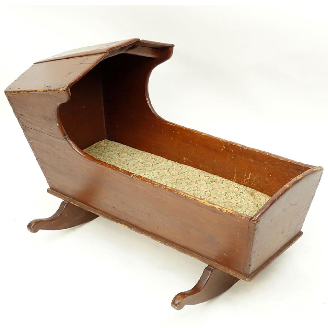Antique American Wood Cradle. Unsigned. Wear, splits: Antique American Wood Cradle. Unsigned. Wear, splits throughout. Measures 24" H x 35" L x 17-1/2" W. Shipping: Third party. (estimate $100-$150)