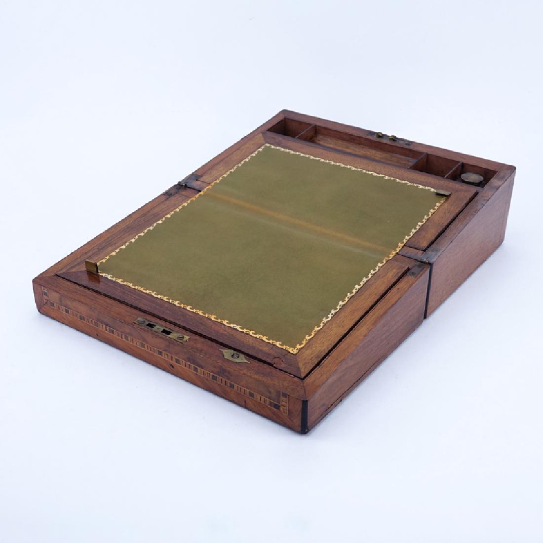 Antique English Writing Box. This box features burled: Antique English Writing Box. This box features burled wood with inlaid marquetry and mother of pearl. Tooled leather writing surface and appropriate compartments for pens, ink, paper etc. One inkbottl