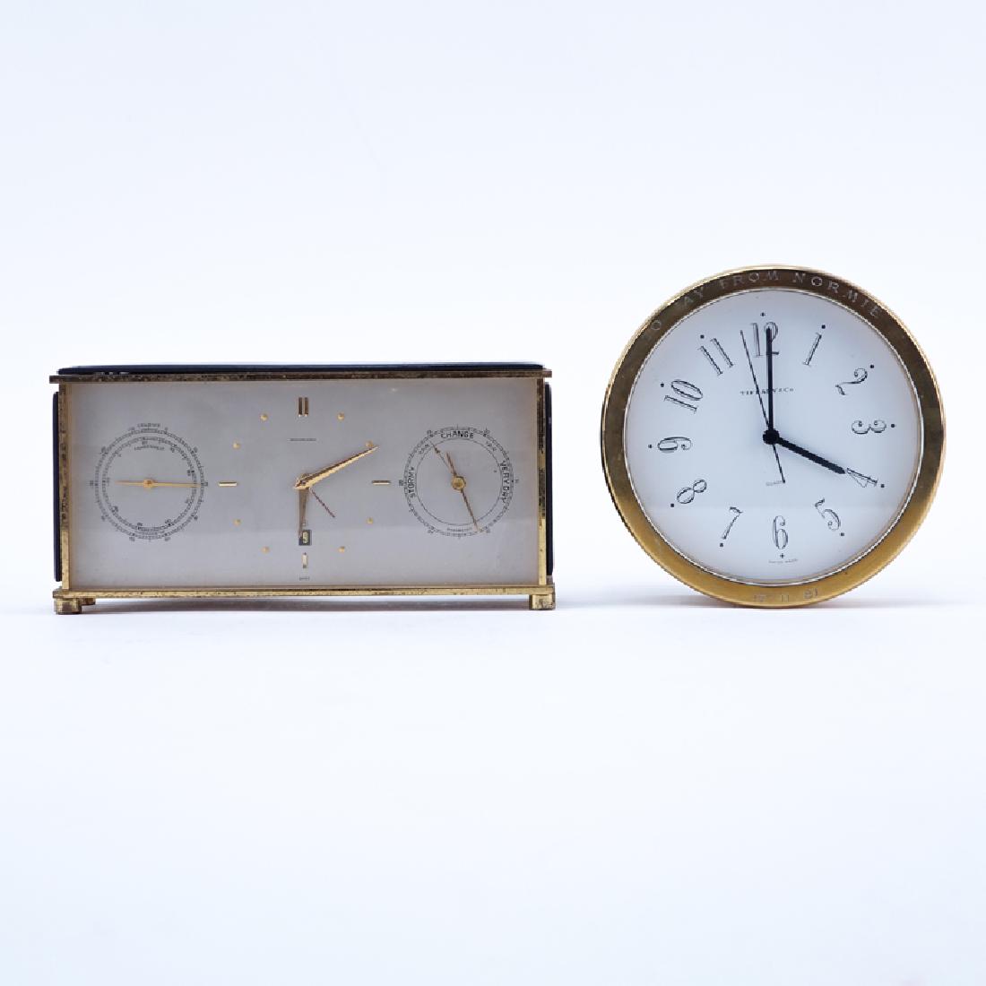 Two Brass Clocks. A Tiffany & Co. round quartz clock, (1 of 8)