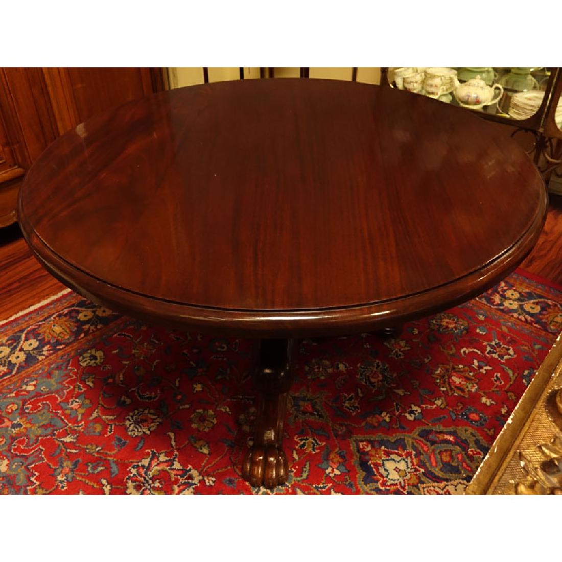 Antique Style Round Carved Mahogany Pedestal Table.: Antique Style Round Carved Mahogany Pedestal Table. Tripod baluster form base with paw feet. Light scratches to top overall good condition. Measures 29-1/4" H x 47" Dia. Shipping: Third party. (estima