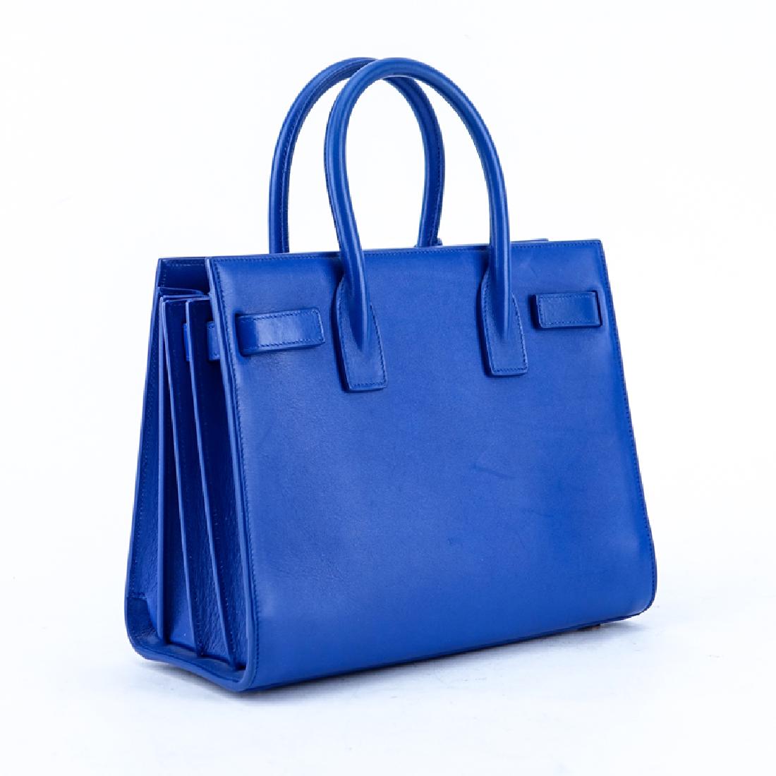Saint Laurent Electric Blue Smooth Calf Leather Sac De: Saint Laurent Electric Blue Smooth Calf Leather Sac De Jour Baby PM. Gold tone hardware. Black leather interior with slot pocket. Optional strap, cadenas and clochette included. Labeled appropriately.