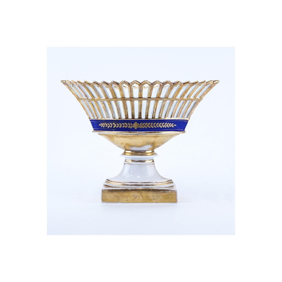 French Empire Style Cobalt and Gilt Reticulate: French Empire Style Cobalt and Gilt Reticulate Porcelain Compote. Unsigned. Rubbing to gilt. Measures 10-3/8" H x 13-7/8" W. Shipping $72.00 (estimate $50-$100)