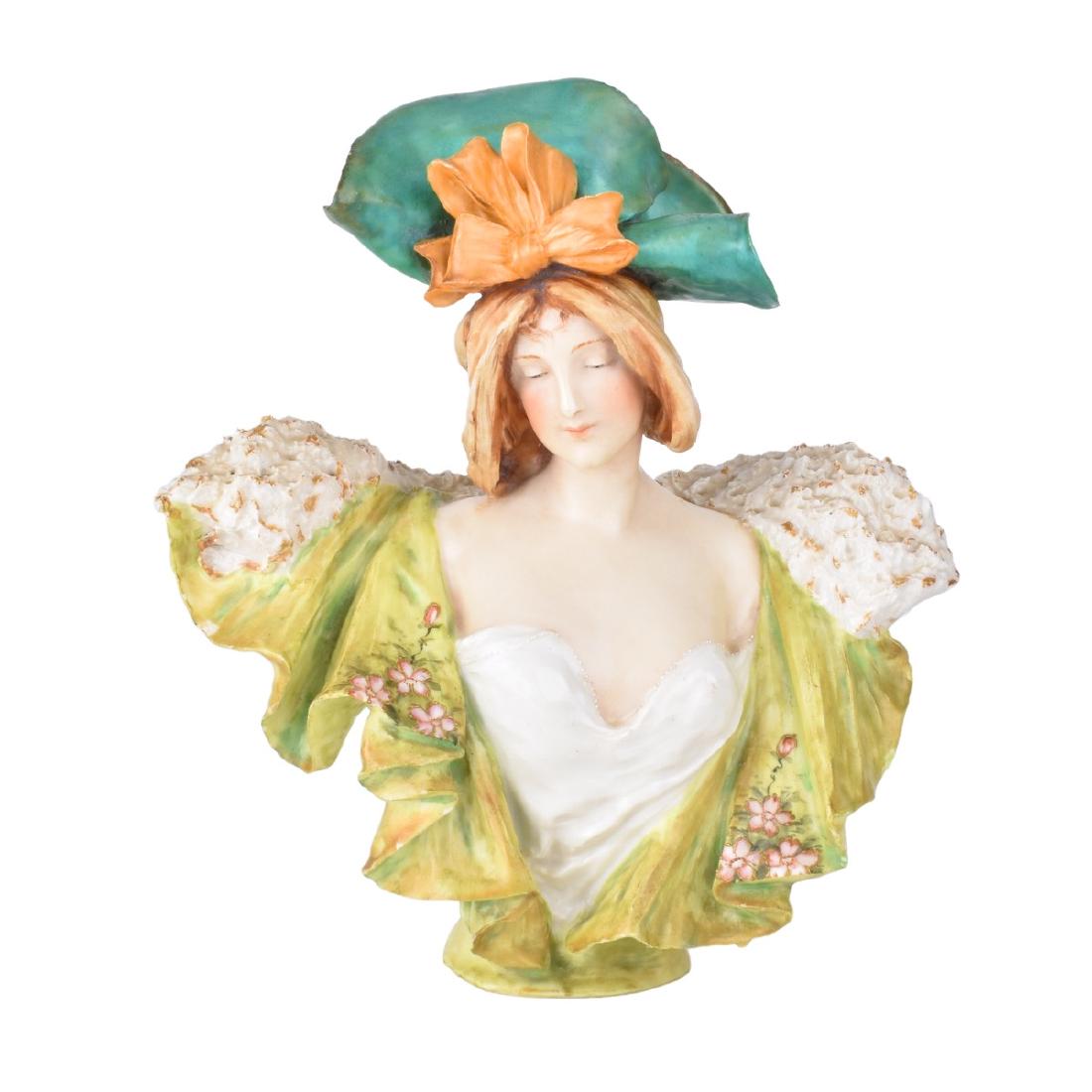 Amphora Figural Pottery Bust: Riessner, Stellmacher & Kessel; Amphora Figural Pottery Bust. Stamped RSTK mark to base and numbered 1223. Measures 11" H x 10" W. Condition: Nicks to edges and rubbing otherwise good condition to ver