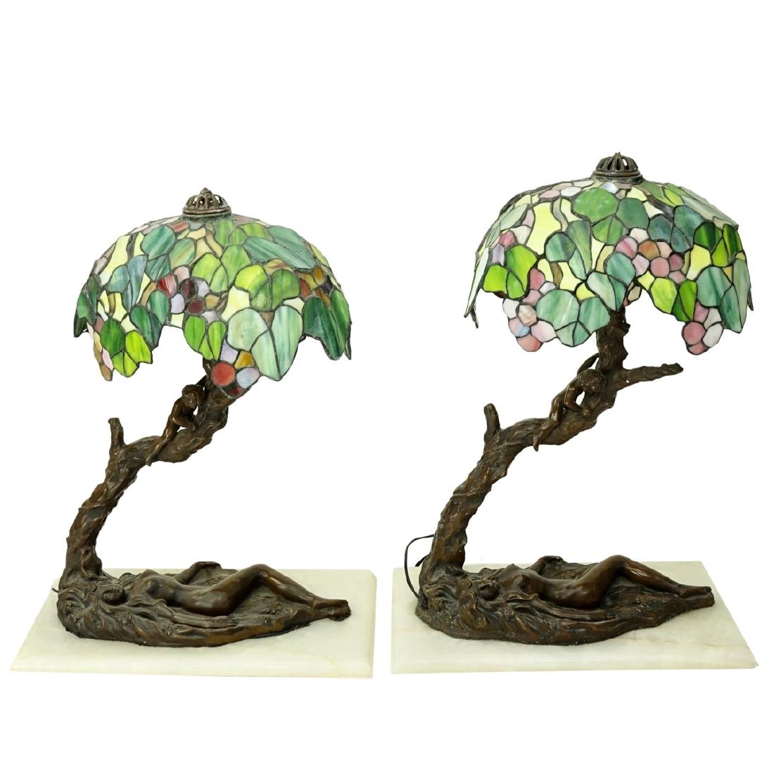 Pair Figural Leaded Glass Lamps: Pair Figural Spelter Leaded Glass Lamps. Onyx bases. Depicts reclining nude under a tree with a child on a limb. Signed illegible and dated 1833. Measures 24" H x 16" W x 8" D. Bases measure 17-1/2" L