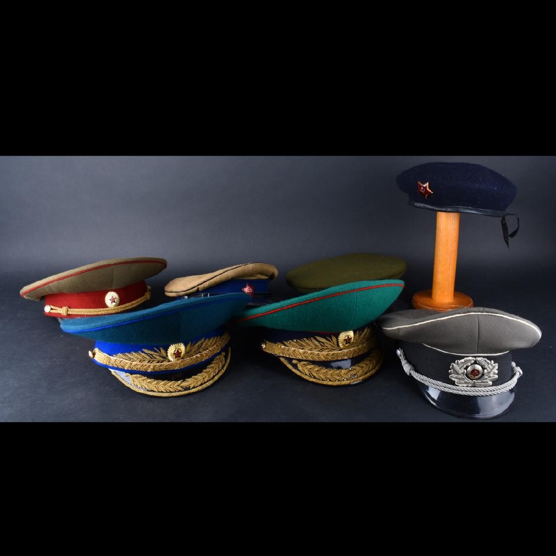 Russian Military Hats: Lot of Seven (7) Russian Military Hats A few with enameled badges. Mostly size 57 and 58. Condition: Wear Estimate: $100.00 - $150.00 Domestic Shipping: 78.00