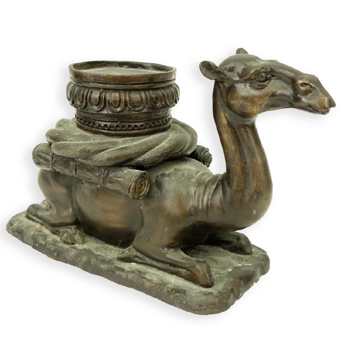 A Bronze Seated Camel Sculpture: A Bronze Seated Camel Sculpture. Unsigned. Measures 7-5/8" H x 12" W. Condition: Rubbing, white spotting Estimate: $50.00 - $100.00 Domestic Shipping: $115.00