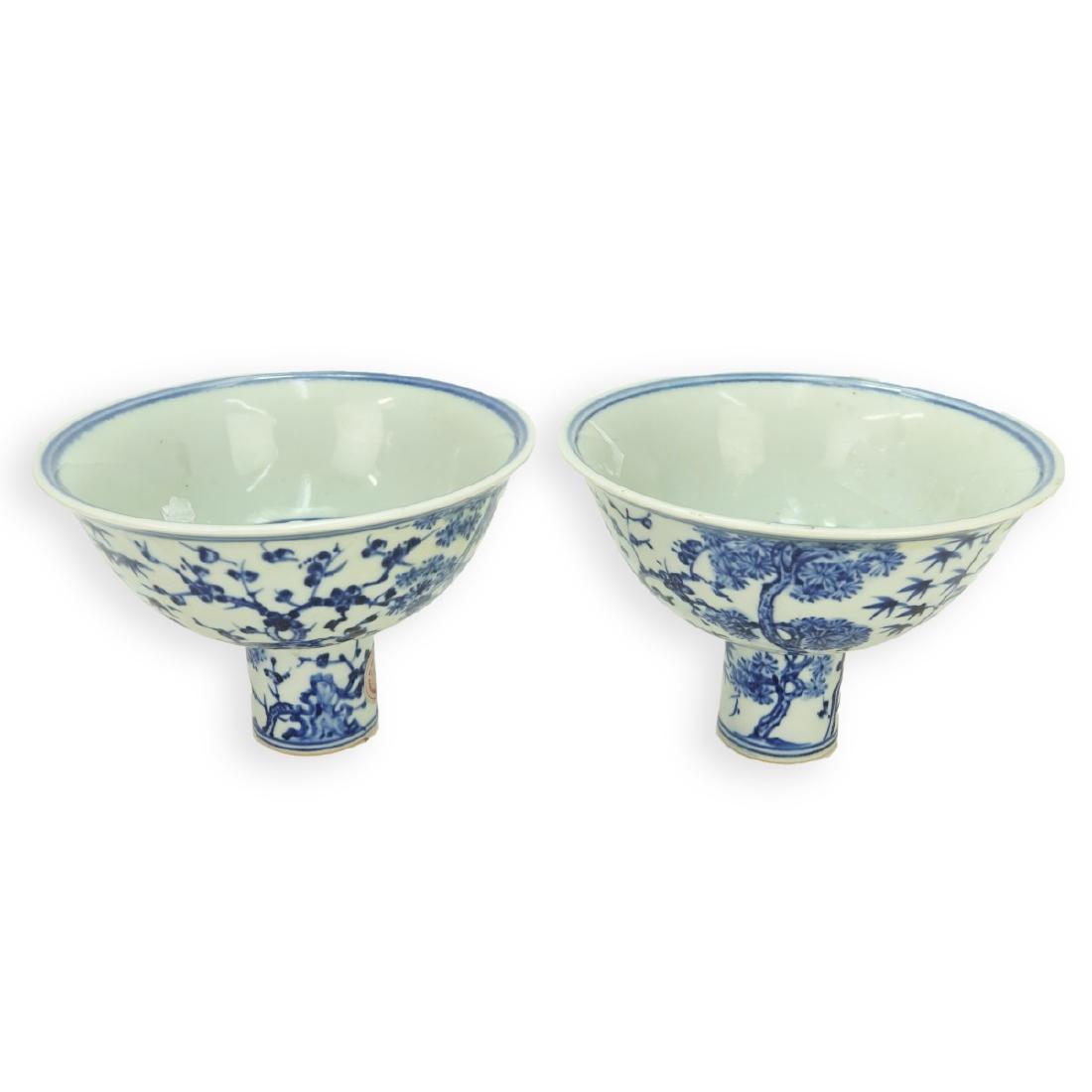 Chinese Pedestal Bowls: Pair of Chinese Blue and White Ming Dynasty Style Porcelain Pedestal Bowls. Signed to base. Measures 4-5/8" H x 6-5/8" Dia. Condition: Good condition Estimate: $150.00 - $250.00 Domestic Shipping: $62