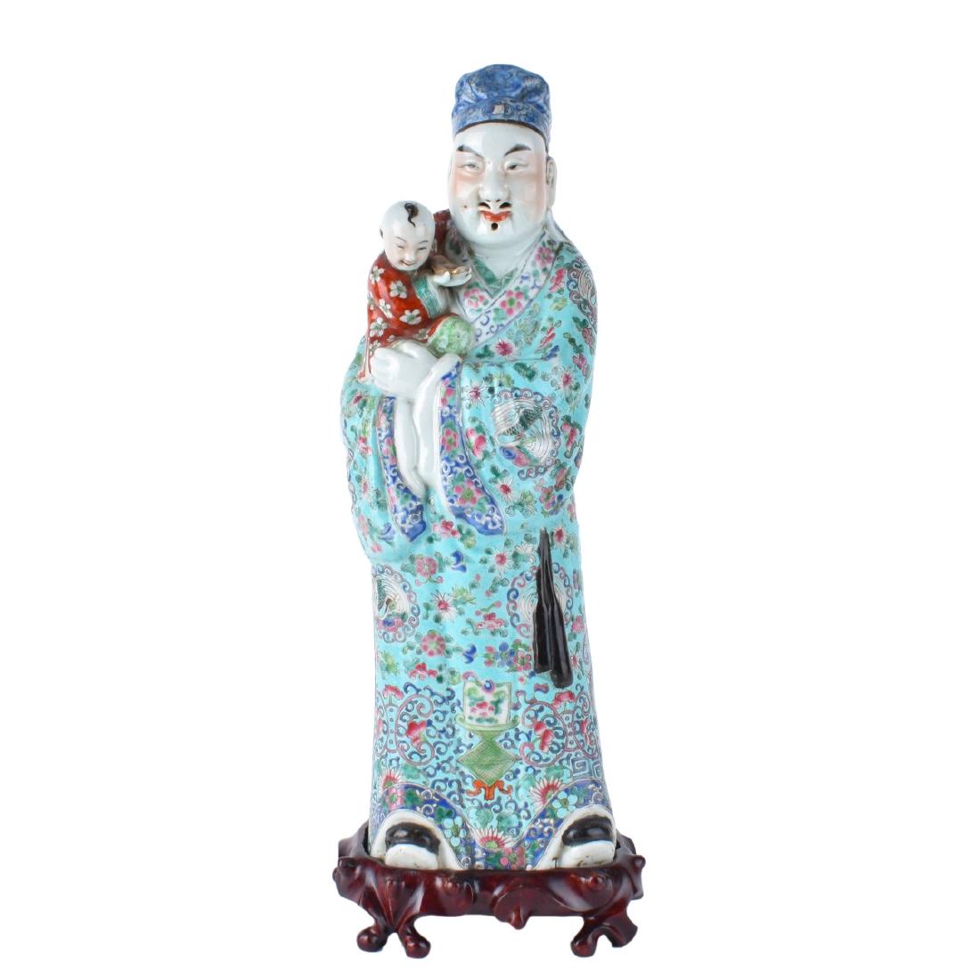 Chinese Immortal and Child: Large Chinese Famille Rose Export Porcelain Immortal with Child on Wooden Stand. Signed to base. Measures 17-1/2" H (figurine), stand measures 2" x 7". Condition: Wear consistent with age otherwise go