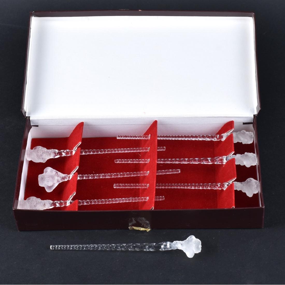 Lalique Swizzle Sticks: Seven (7) Lalique Crystal Swizzle Sticks. Six in box and one loose. Unsigned. Each stick measures 5" L. Condition: Good condition. Estimate: $50.00 - $100.00 Domestic Shipping: $38.00