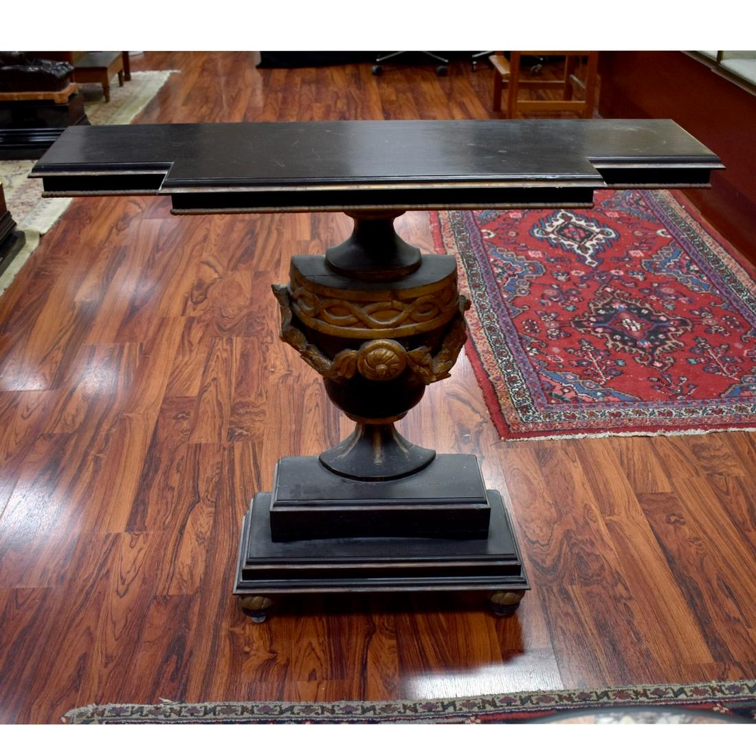 Neoclassical Style Console Table: Neoclassical Style Black Lacquer and Gilt Carved Console Table, Late 19th with Later Parts. Urn base and stands on bracket feet. Measures 36-1/2" H x 43-1/2" W x 14-1/4" D. Condition: Rubbing to gilt,