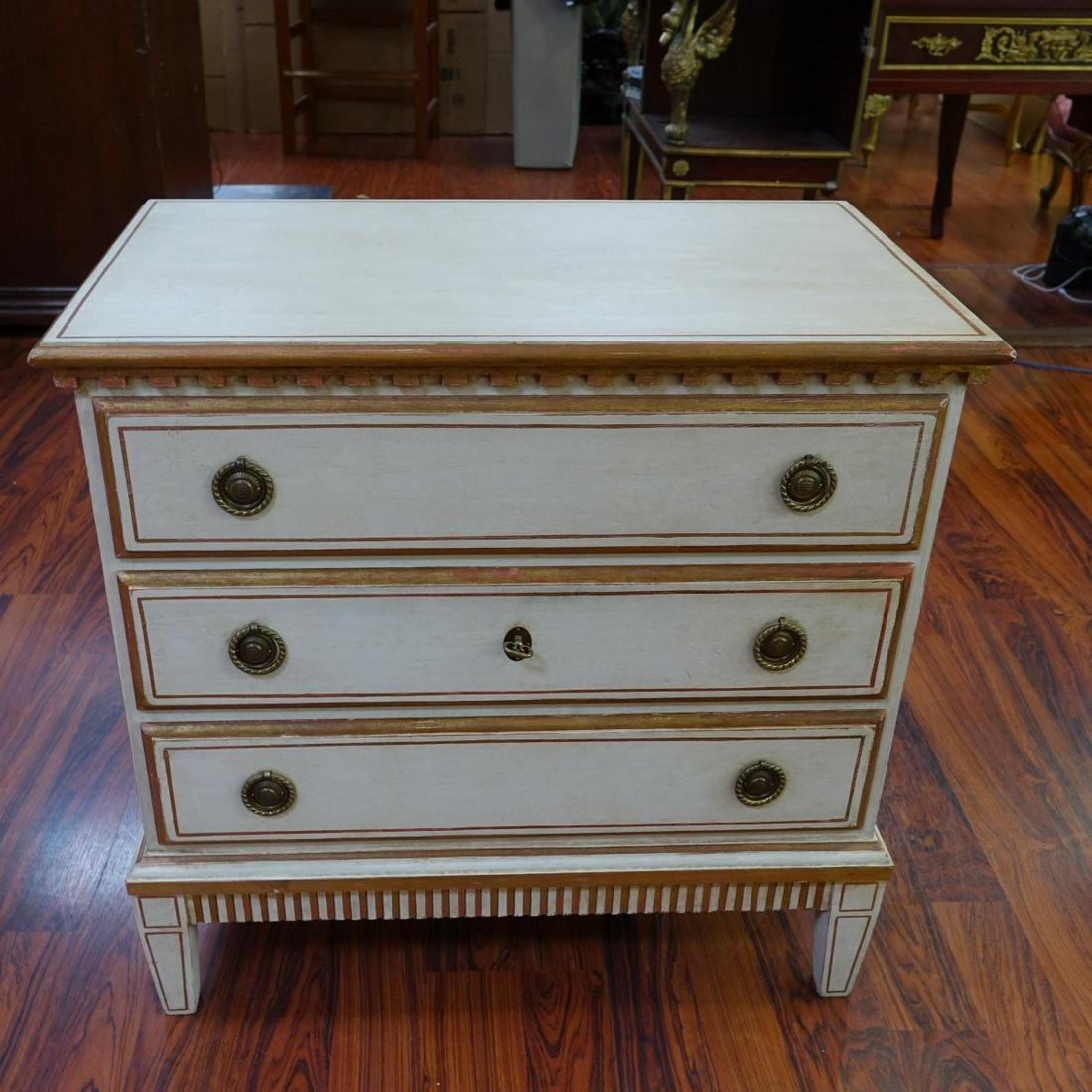 Jansen Style Neoclassical Chest of Drawers: Style of Jansen Neoclassical Style White and Gilt Painted Chest of Drawers/Nightstands. Three sliding drawers, brass pulls, and stands on tapering legs. Measures 29-1/4" H x 30" W x 18" D. Condition: 