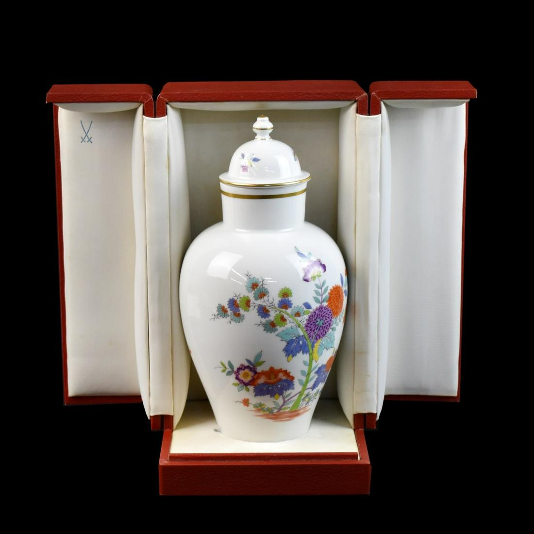 Meissen Porcelain Vase with Cover: 20th Century Meissen Porcelain Vase with Cover and Original Fitted Box. Signed with crossed sword mark. Vase measures 10-3/8" x 4-1/2". Box measures 6" x 11-1/4" x 6". Condition: Good condition Estima