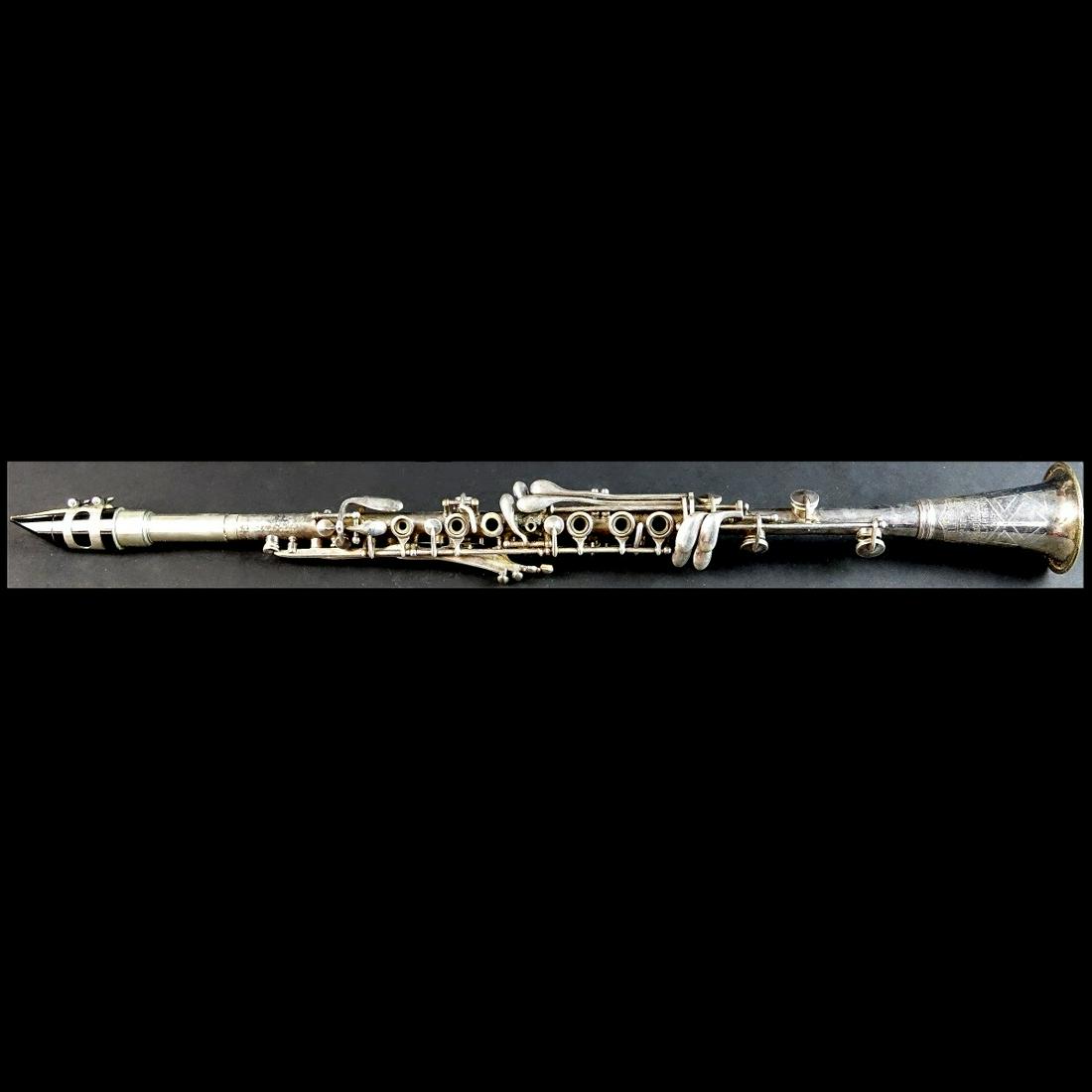 Frank Holton Clarinet: Vintage Frank Holton, Elkhorn Wisconsin Silver Plated Clarinet Presented in Fitted Box. Inscribed and numbered 139418. A few extra parts. Clarinet measures 26" L. Box measures 4" H x 22-1/4" W x 4-1/4
